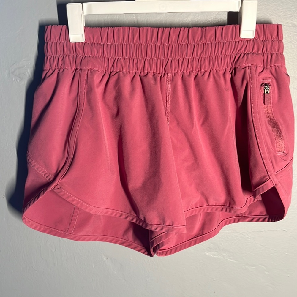 Dark pink Lululemon running shorts.
